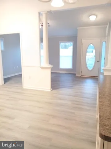 a view of a room with wooden floor and window