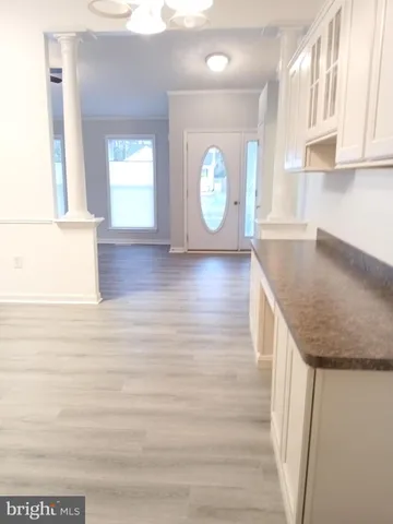 a kitchen with granite countertop a sink a stove and cabinets