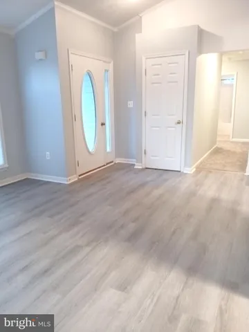 an empty room with mirror and windows