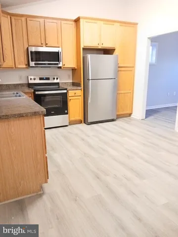 a kitchen with a refrigerator stove and microwave