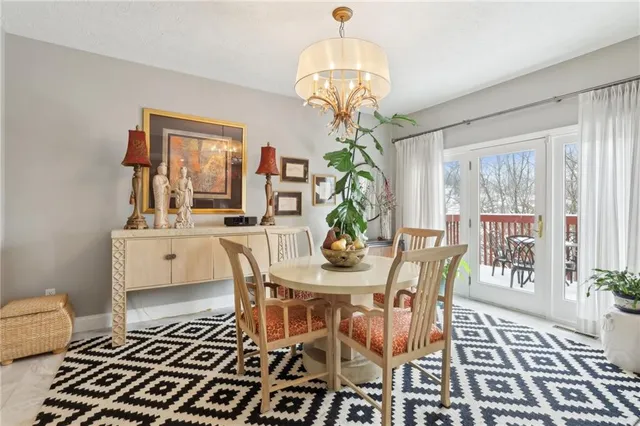a view of a dining room with furniture a chandelier and wooden floor