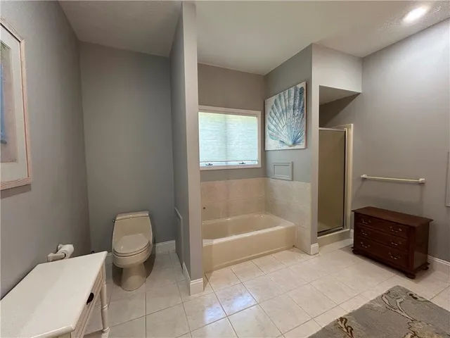 a bathroom with a toilet a sink and bathtub