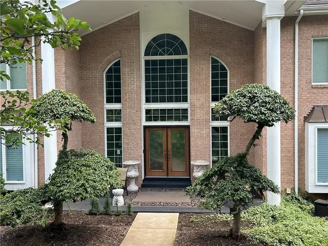 a front view of a house with garden