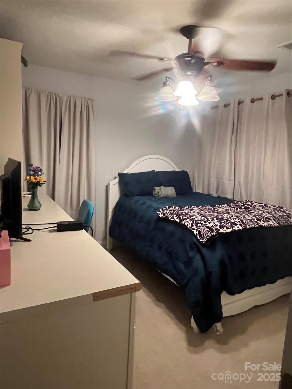 226 Waterlemon Way Monroe, NC 28110 - Photo 13 of 20 a bedroom with a bed and a chandelier