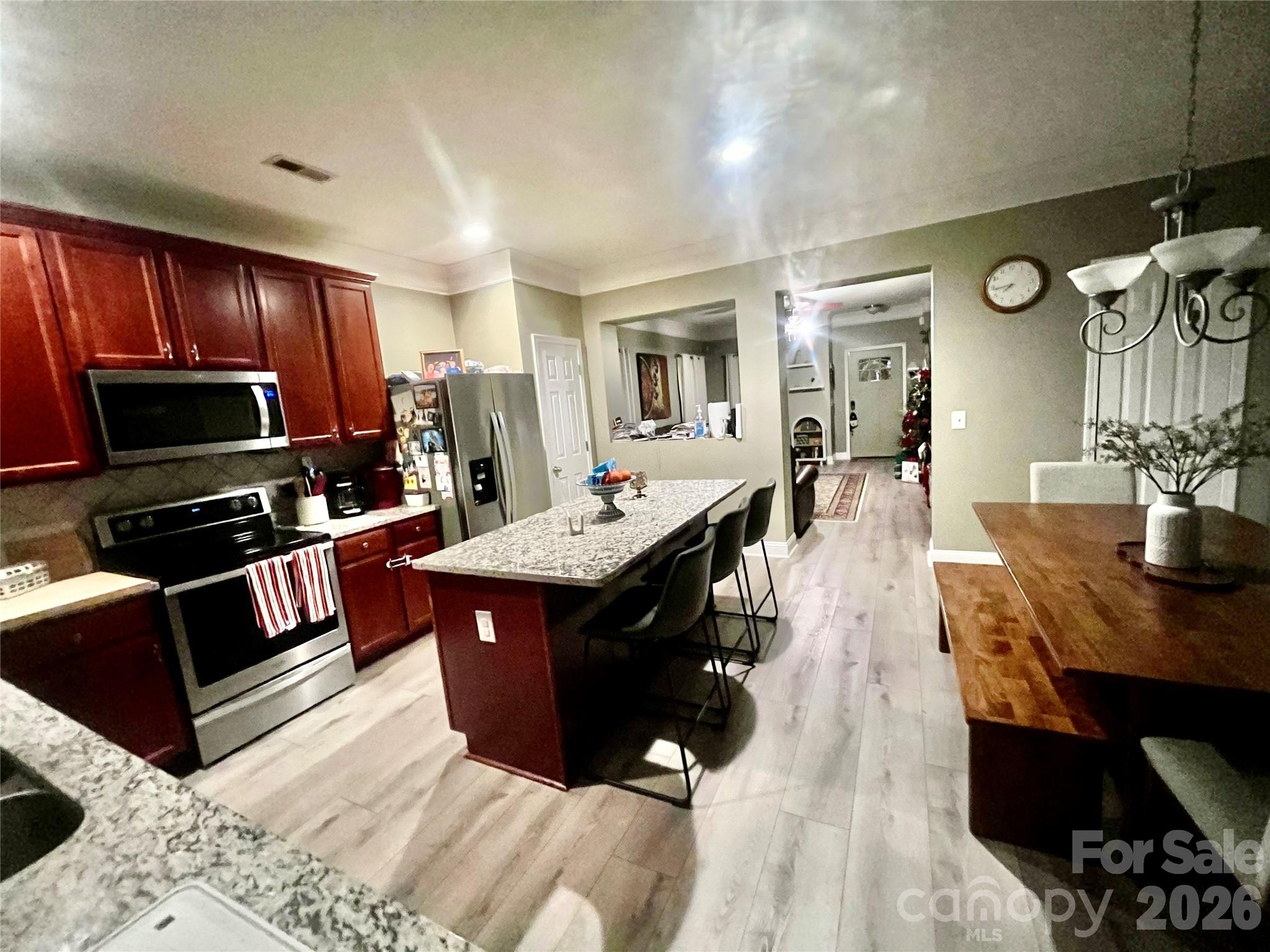 226 Waterlemon Way Monroe, NC 28110 - Photo 14 of 29 a kitchen with stainless steel appliances kitchen island granite countertop a stove refrigerator and cabinets