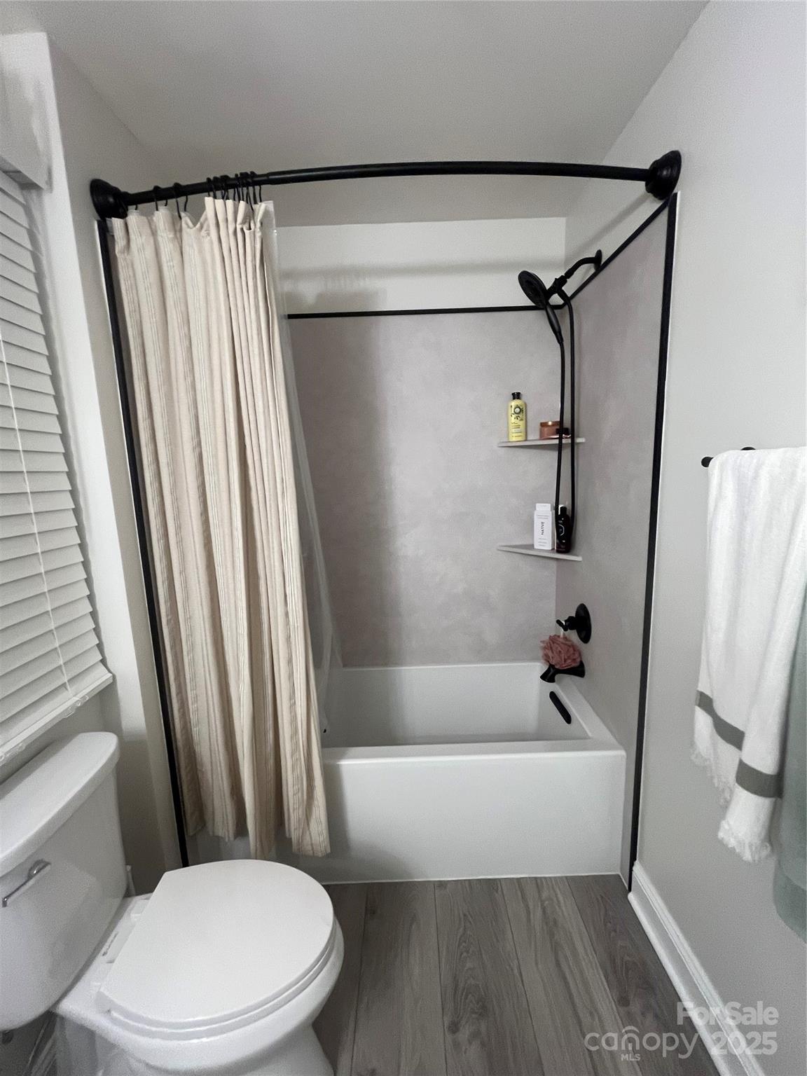 226 Waterlemon Way Monroe, NC 28110 - Photo 14 of 20 a white toilet sitting next to a bath tub