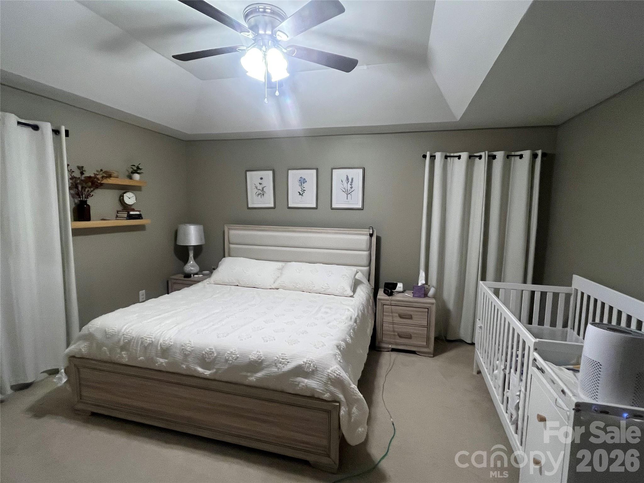 226 Waterlemon Way Monroe, NC 28110 - Photo 18 of 29 a bedroom with a bed and a chandelier
