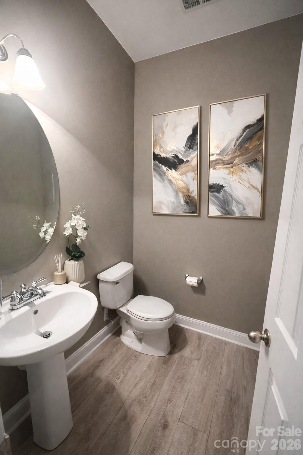 226 Waterlemon Way Monroe, NC 28110 - Photo 4 of 29 a bathroom with a toilet sink and mirror