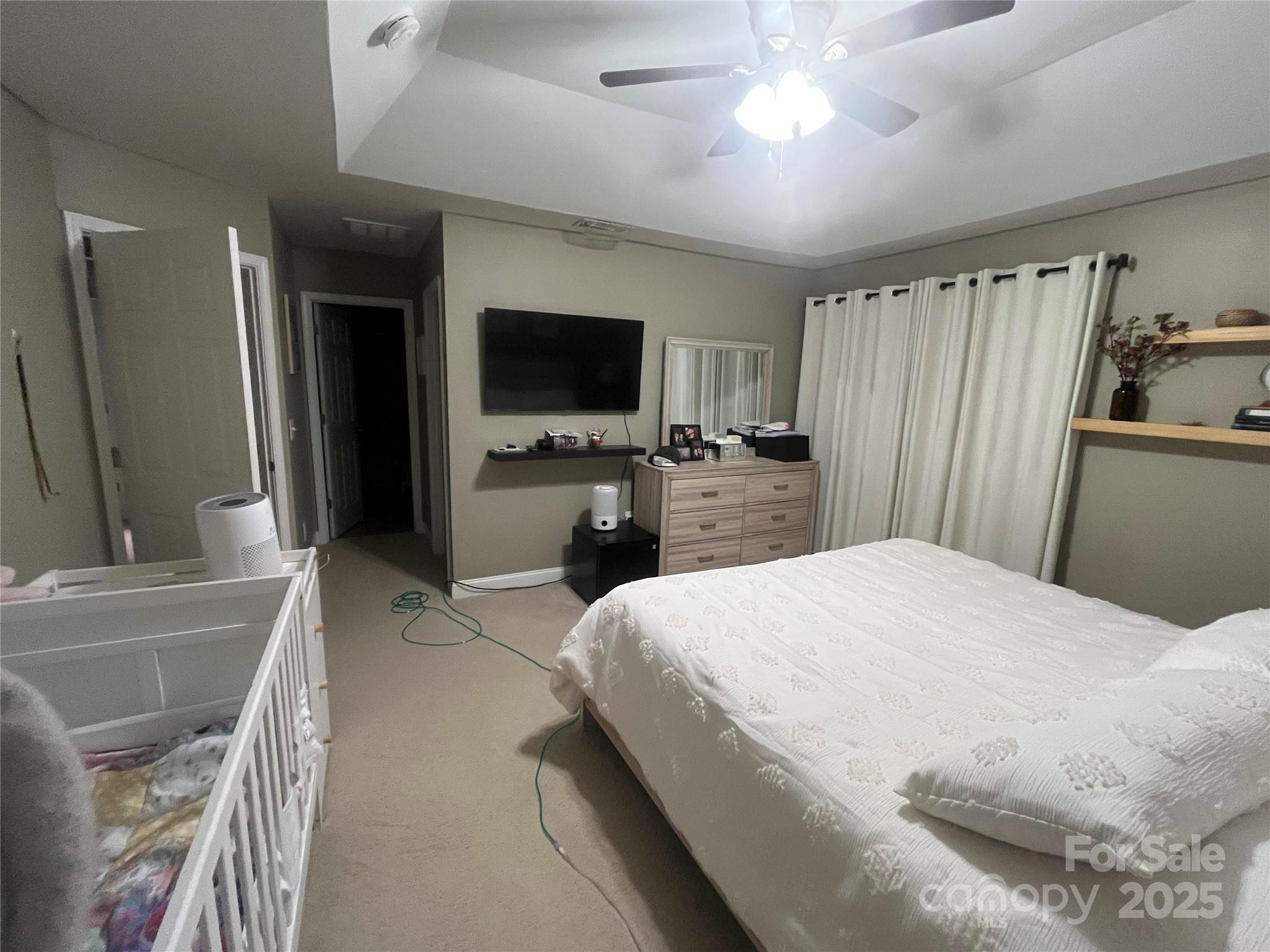 226 Waterlemon Way Monroe, NC 28110 - Photo 10 of 20 a bedroom with a bed and a flat screen tv