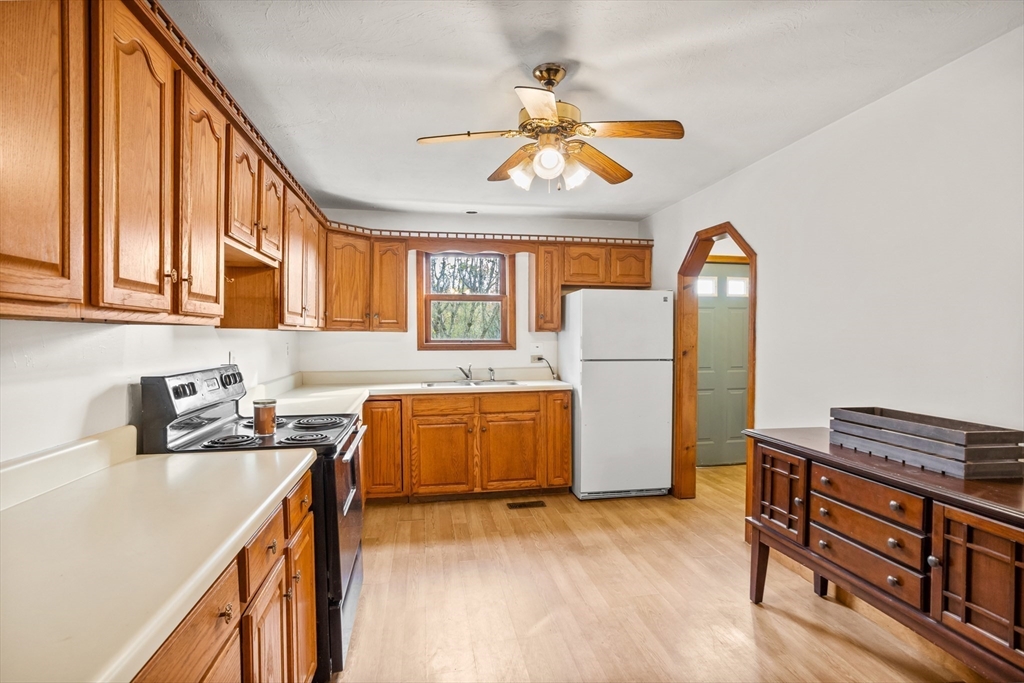 16 Neale Road Royalston, MA 01368 - Photo 11 of 38 a kitchen with stainless steel appliances granite countertop a refrigerator a stove a sink dishwasher and a dining table with wooden floor