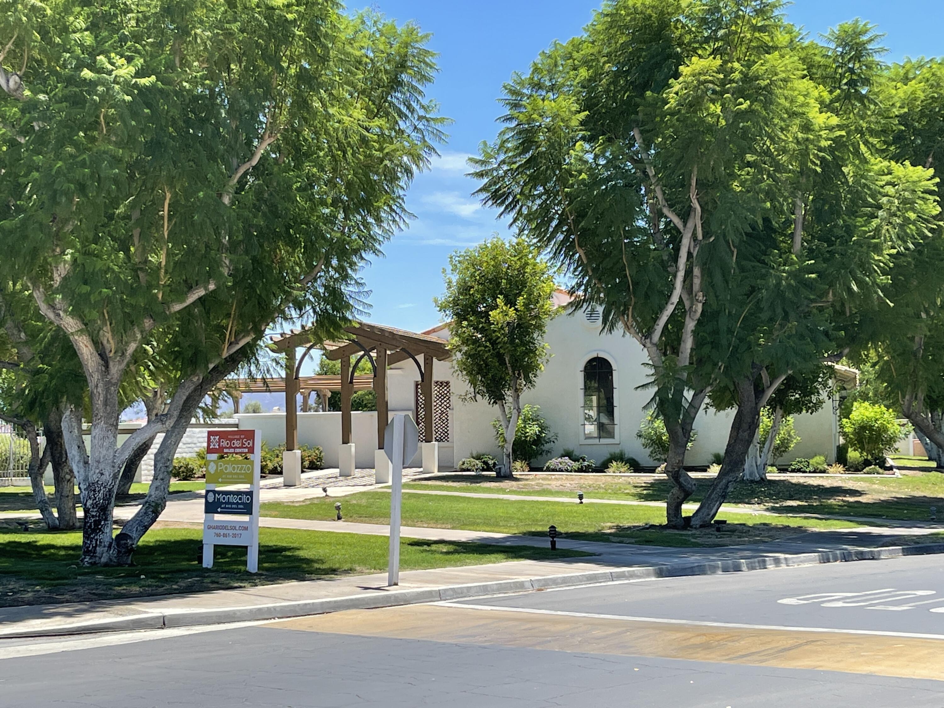 69573 Corta Celeste Cathedral City, CA 92234 - Photo 10 of 23 a view of swimming pool with lawn chairs and large trees
