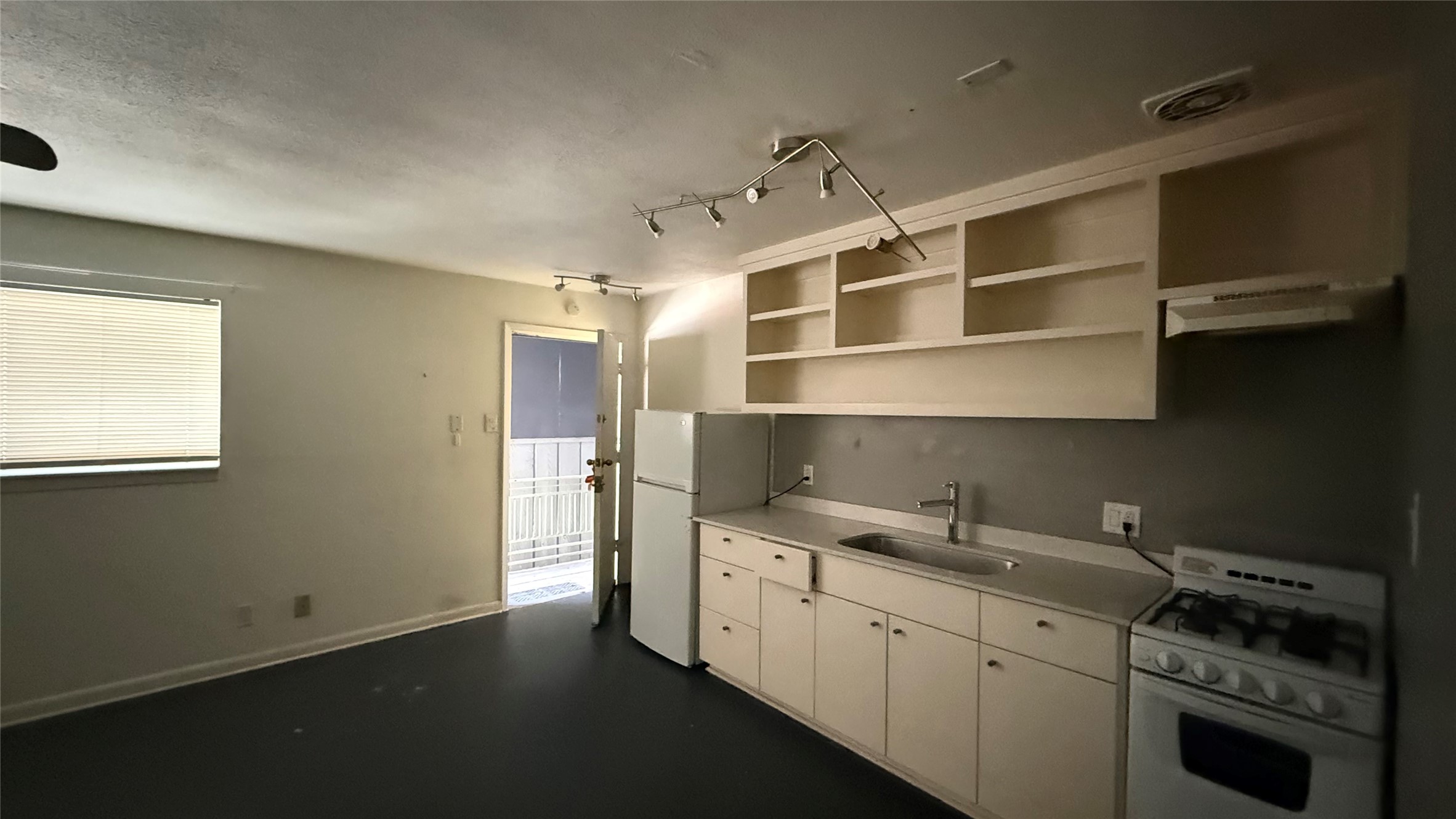 219 West Alabama Street, Unit 32 Houston, TX 77006 - Photo 1 of 10 a kitchen with stainless steel appliances a sink stove and cabinets
