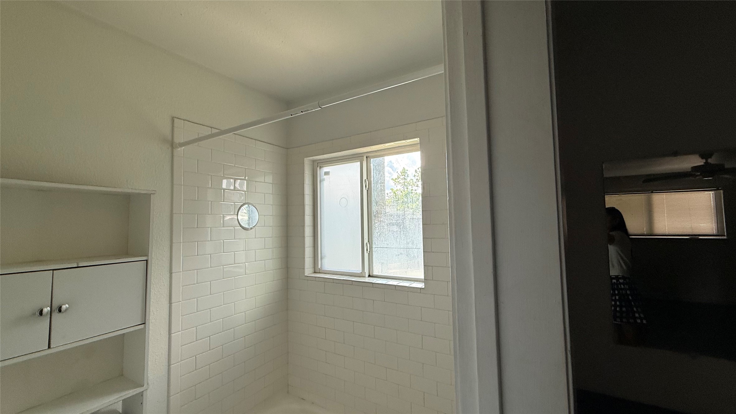 219 West Alabama Street, Unit 32 Houston, TX 77006 - Photo 2 of 10 a bathroom with a window and a shower