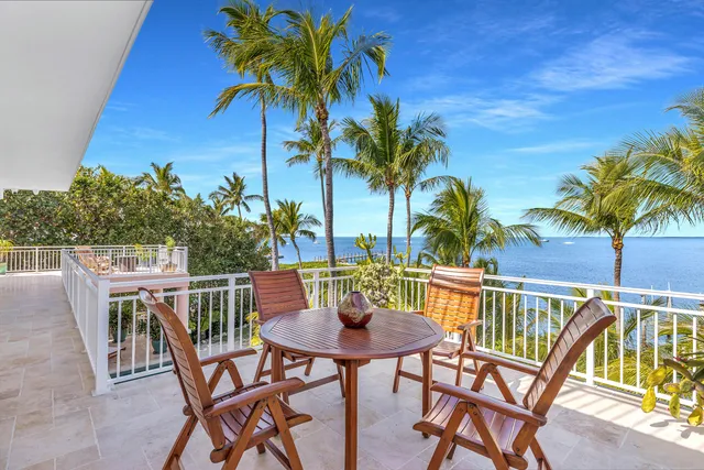a view of a swimming pool with a table and chairs