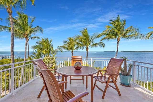 a view of a chairs and table in patio