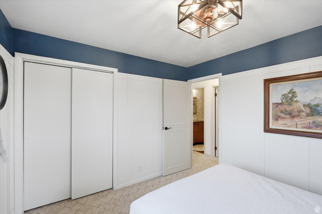 165 Main Street Georgetown, ID 83239 - Photo 19 of 50 Bedroom with a chandelier, connected bathroom, and two closets