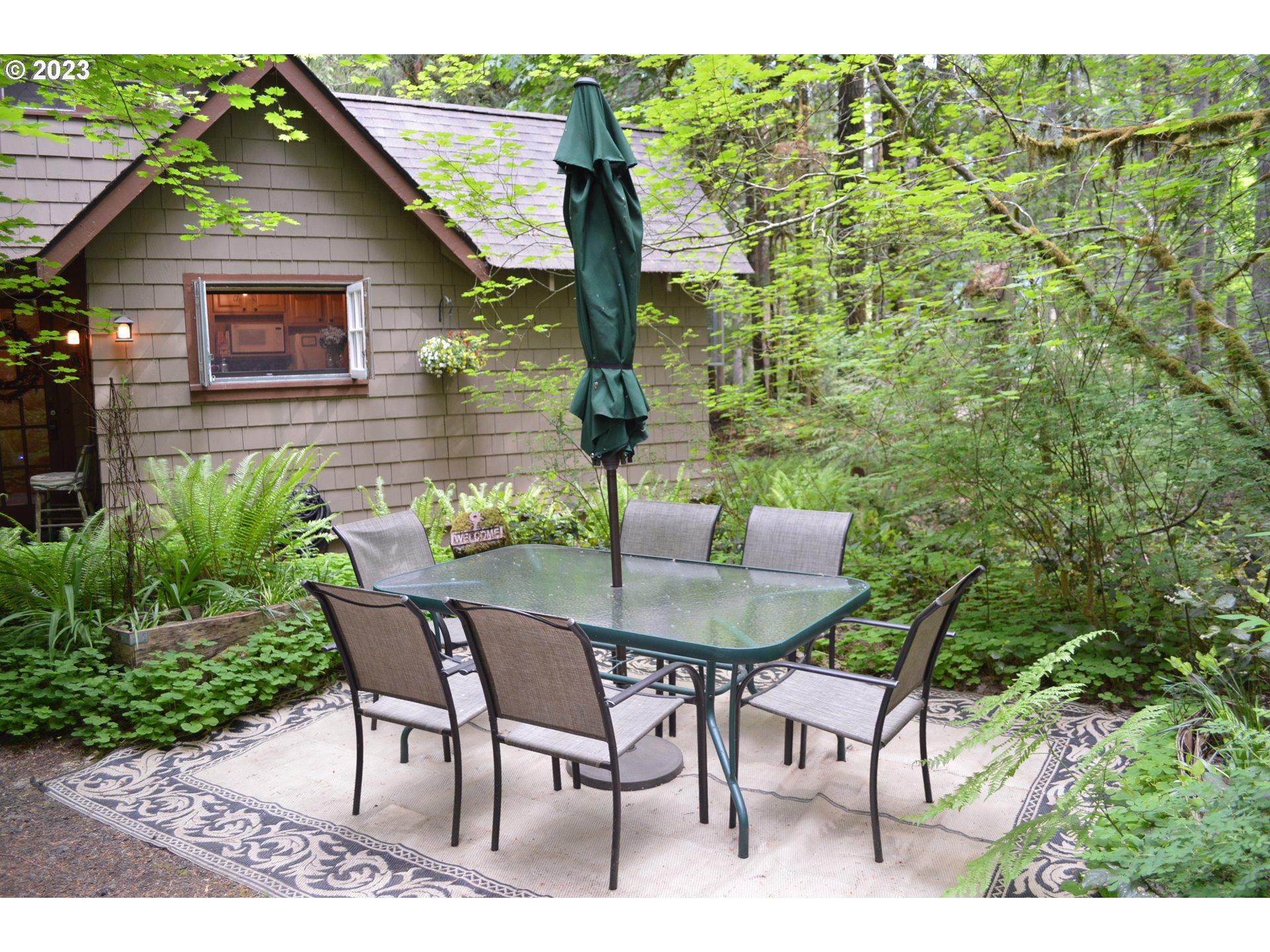 27502 Road 20 Rhododendron, OR 97049 - Photo 2 of 48 a backyard of a house with table and chairs