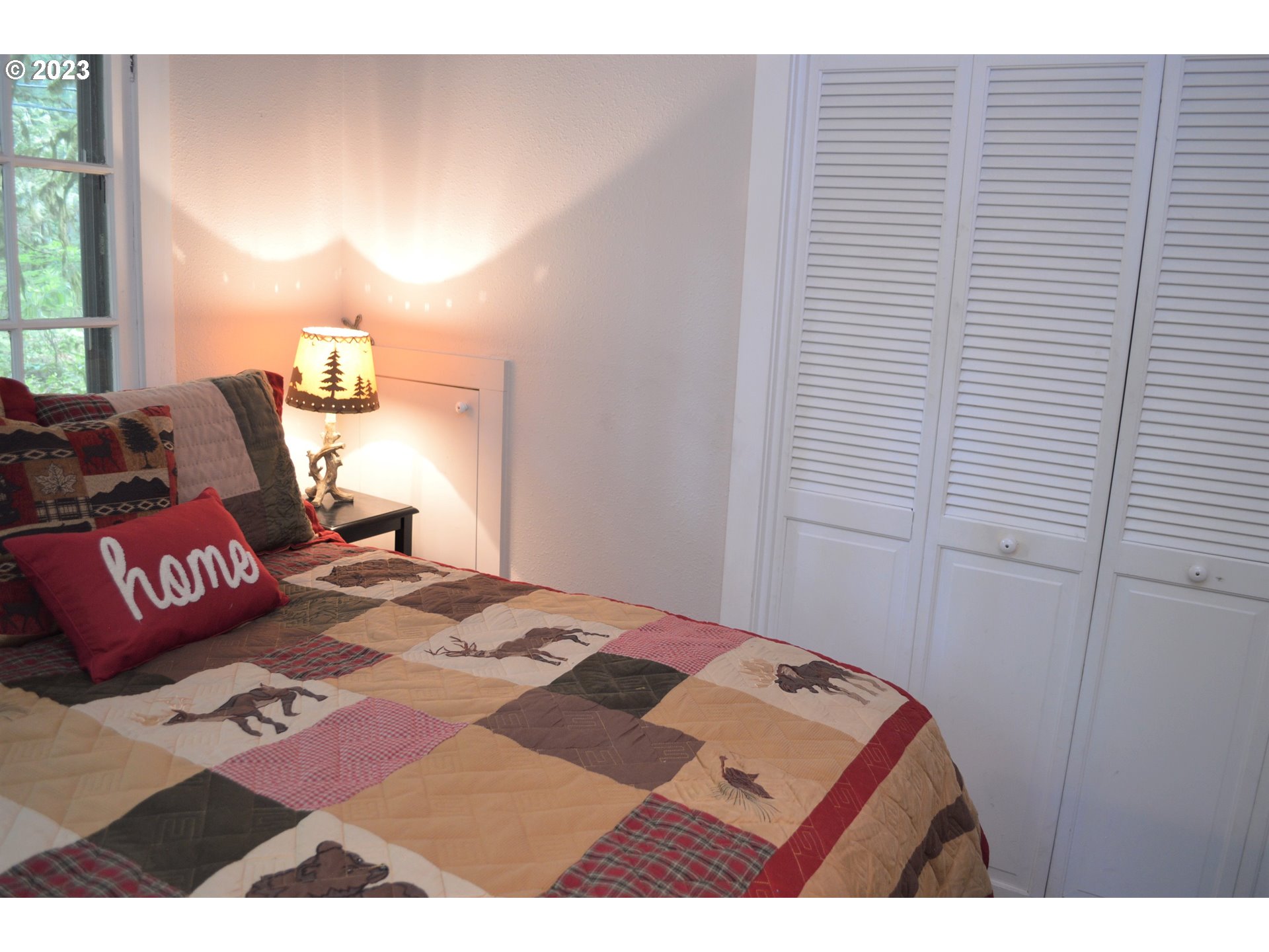 27502 Road 20 Rhododendron, OR 97049 - Photo 34 of 48 a bedroom with a bed and a lamp