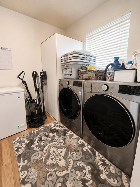 221 Winding Way Road Marble Falls, TX 78654 - Photo 11 of 19 Efficient laundry setup with modern appliances and durable flooring. The pantry is also in this room.