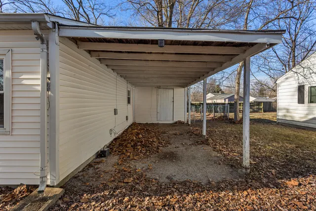 a white house that has a tree in front of it