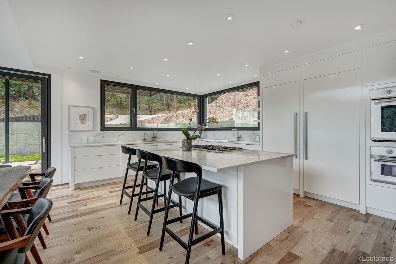 228 Lion Point Boulder, CO 80302 - Photo 19 of 50 a kitchen with stainless steel appliances a table and chairs in it