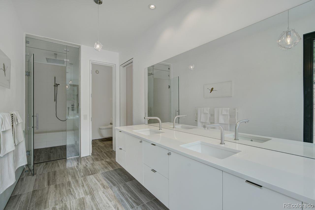 228 Lion Point Boulder, CO 80302 - Photo 36 of 50 a bathroom with a double vanity sink mirror and shower