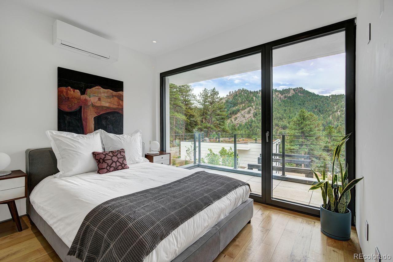 228 Lion Point Boulder, CO 80302 - Photo 39 of 50 a bedroom with a large bed and a large window