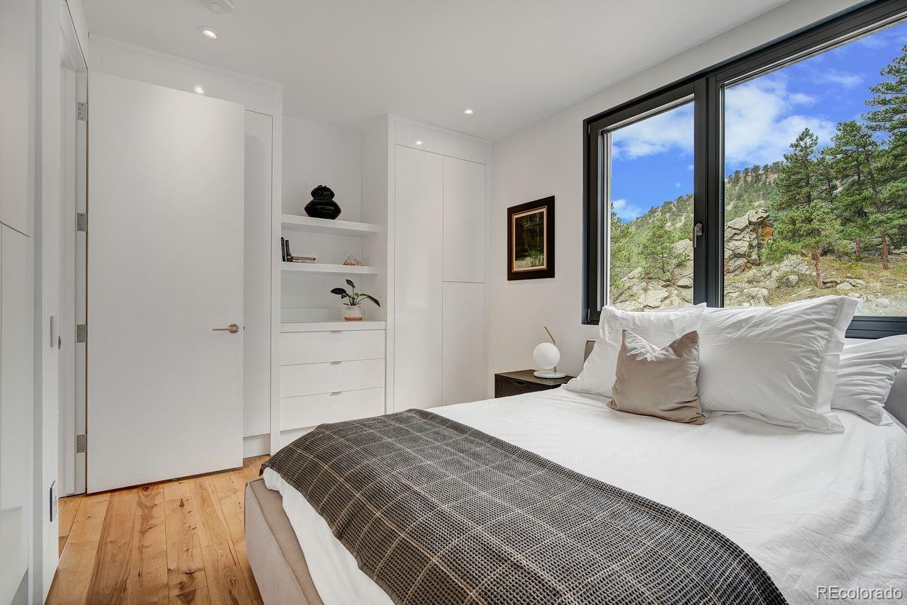 228 Lion Point Boulder, CO 80302 - Photo 41 of 50 a bedroom with a large bed and a large window