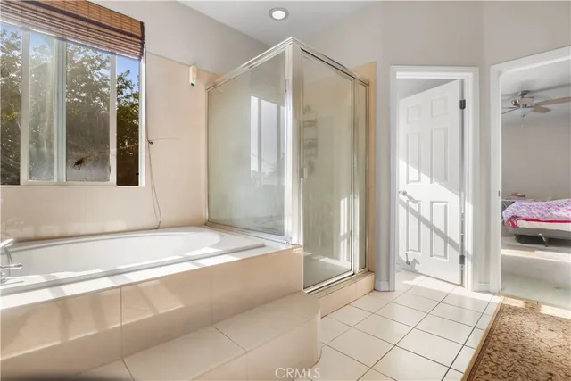 a spacious bathroom with a tub shower and sink