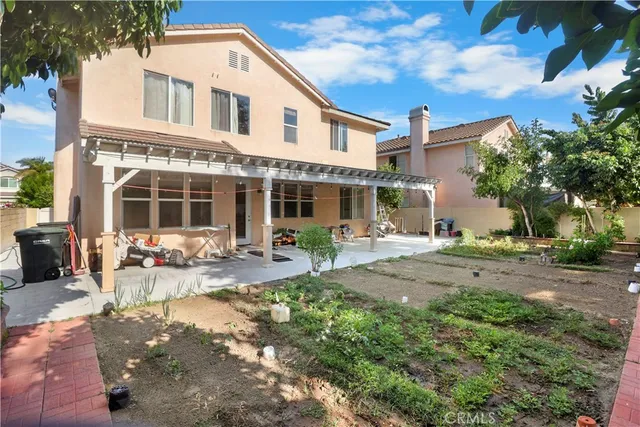 a view of a house with backyard sitting area and garden