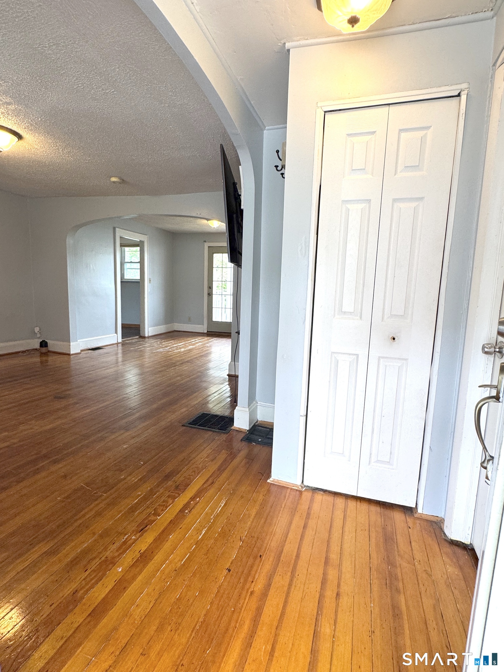 6-8 Vose Street Ansonia, CT 06401 - Photo 16 of 37 1st floor front entrance foyer. leads into living room and then dining room at the far end.