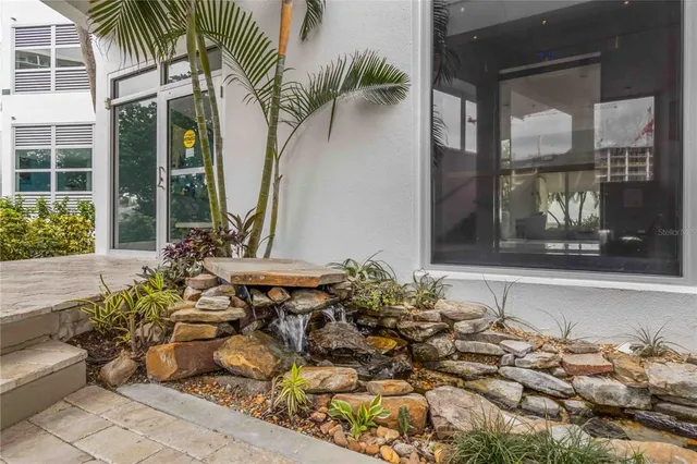 a view of a dining room with furniture large windows and wooden floor