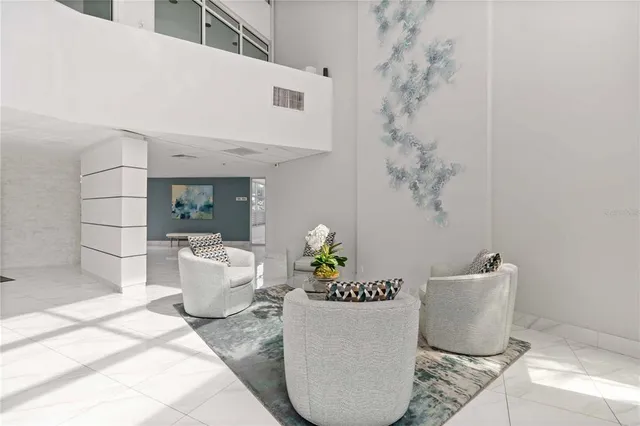 a living room with furniture and a potted plant