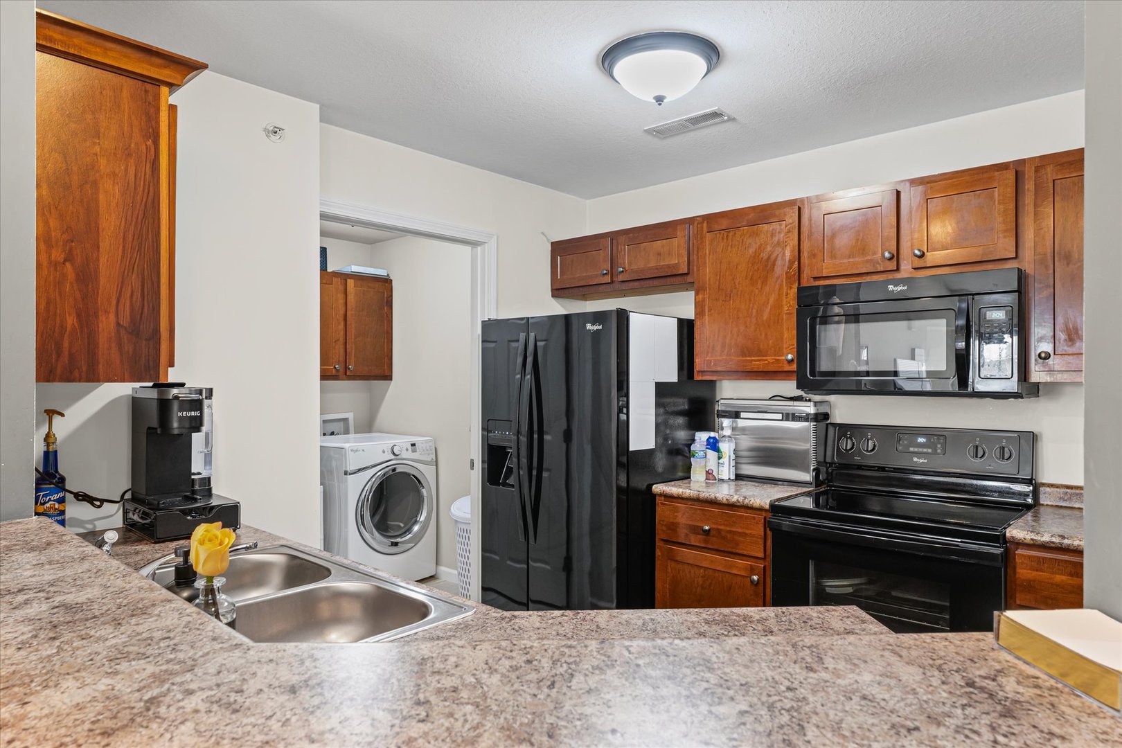 3044 East Stillwater Landing, Unit 201 Urbana, IL 61802 - Photo 16 of 28 a kitchen with stainless steel appliances granite countertop a refrigerator stove and sink