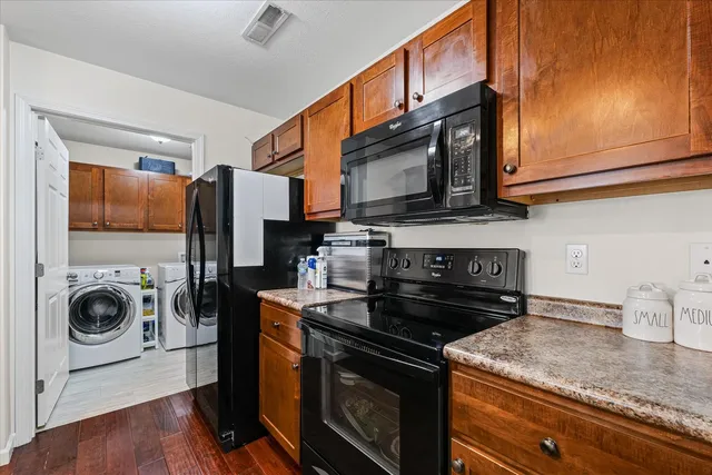 a kitchen with stainless steel appliances granite countertop a stove a microwave and cabinets