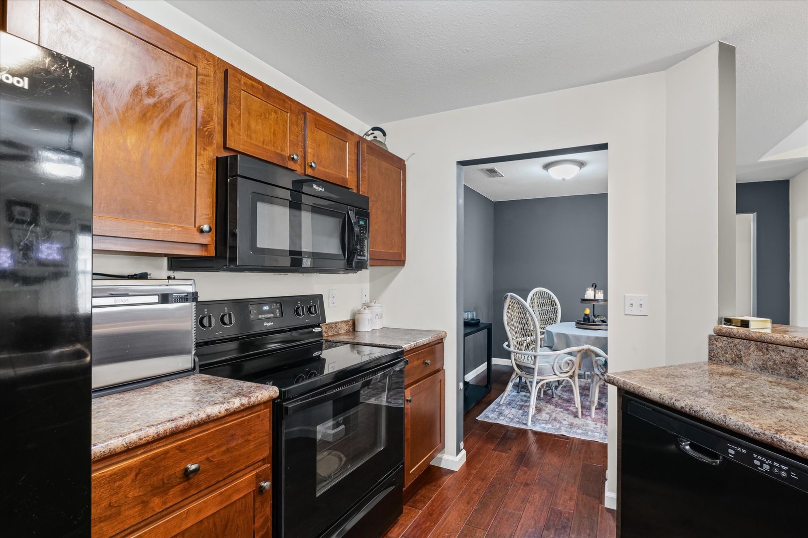 3044 East Stillwater Landing, Unit 201 Urbana, IL 61802 - Photo 19 of 28 a kitchen with stainless steel appliances granite countertop a stove a sink and a microwave
