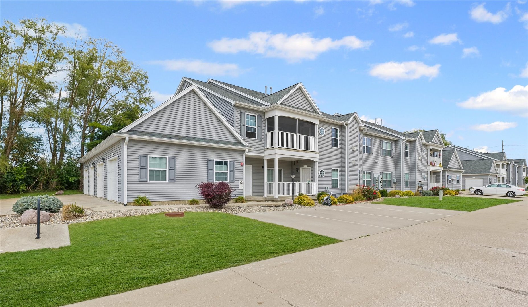 3044 East Stillwater Landing, Unit 201 Urbana, IL 61802 - Photo 2 of 28 a front view of a house with a garden and plants