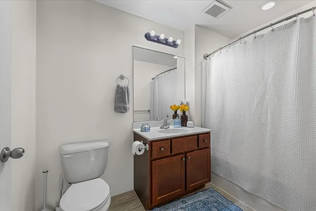 a bathroom with a toilet a sink and mirror