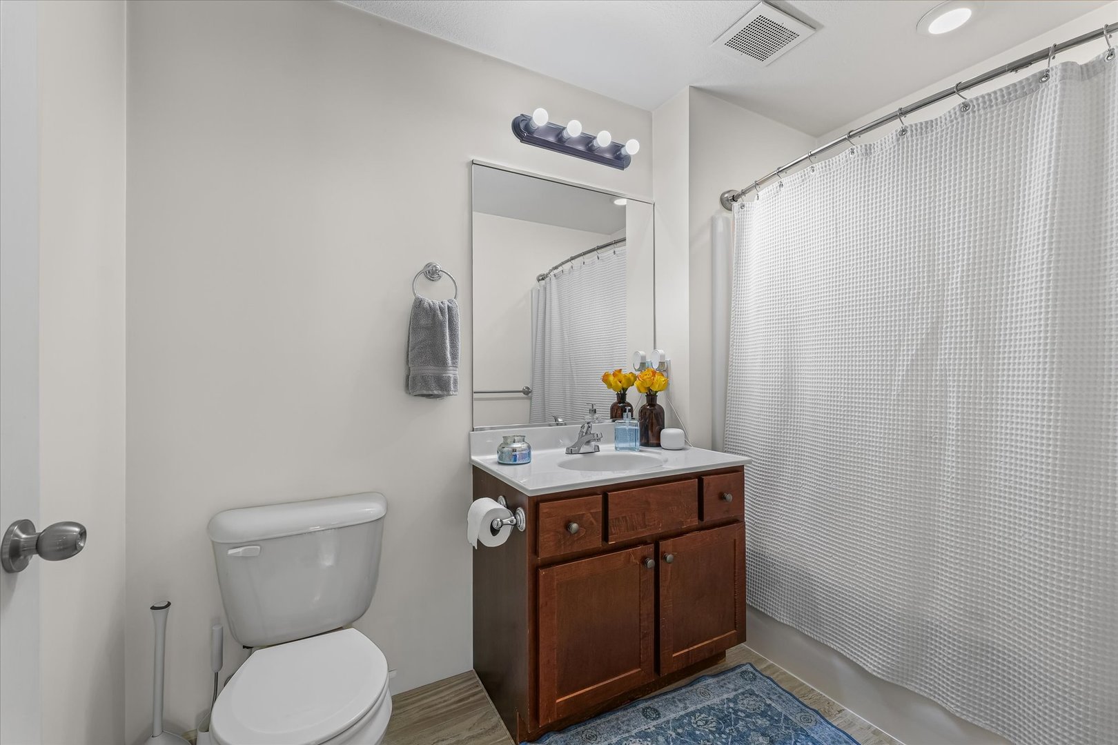 3044 East Stillwater Landing, Unit 201 Urbana, IL 61802 - Photo 21 of 28 a bathroom with a toilet a sink and mirror