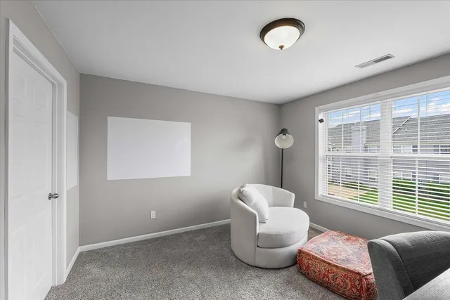 a living room with furniture a window and a chandelier