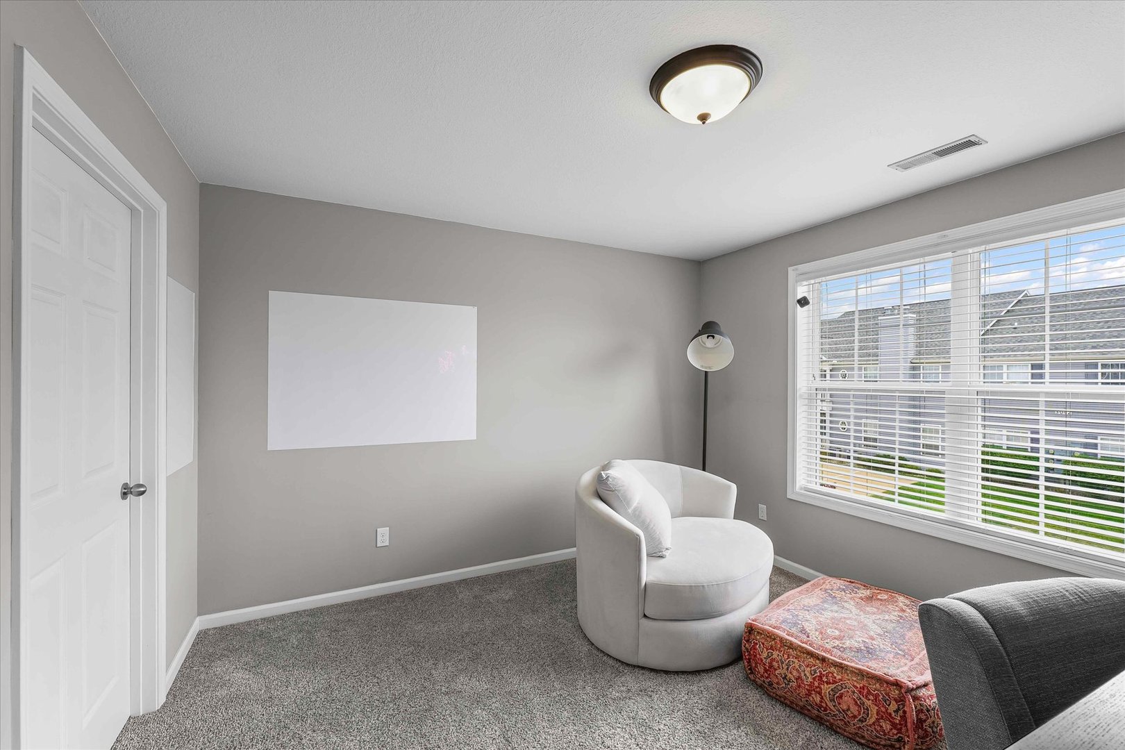 3044 East Stillwater Landing, Unit 201 Urbana, IL 61802 - Photo 22 of 28 a living room with furniture a window and a chandelier