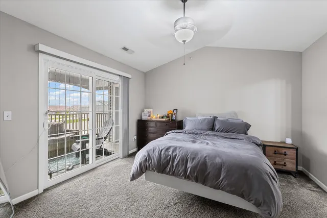 a spacious bedroom with a bed and a tv