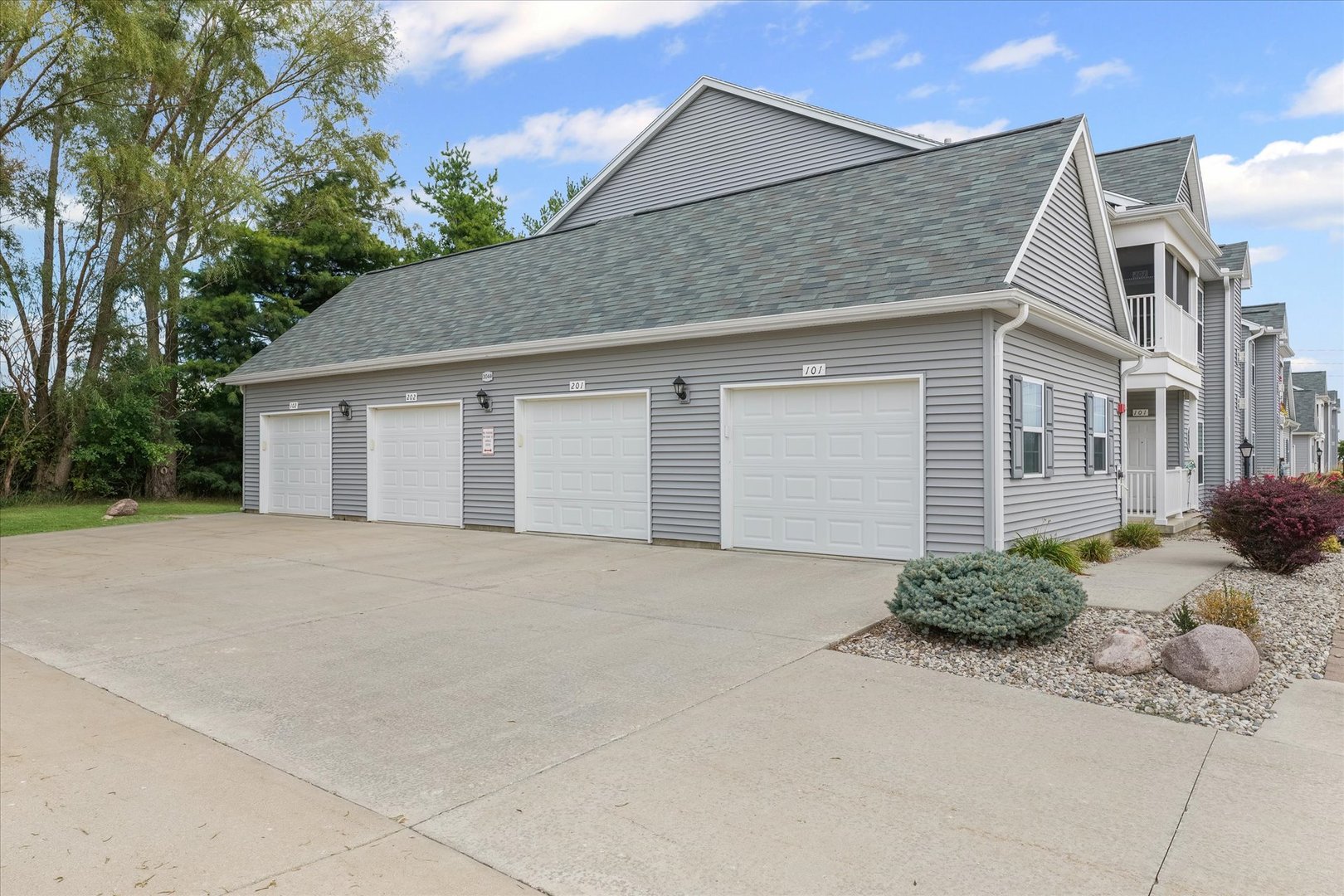 3044 East Stillwater Landing, Unit 201 Urbana, IL 61802 - Photo 27 of 28 a front view of a house with a yard and garage