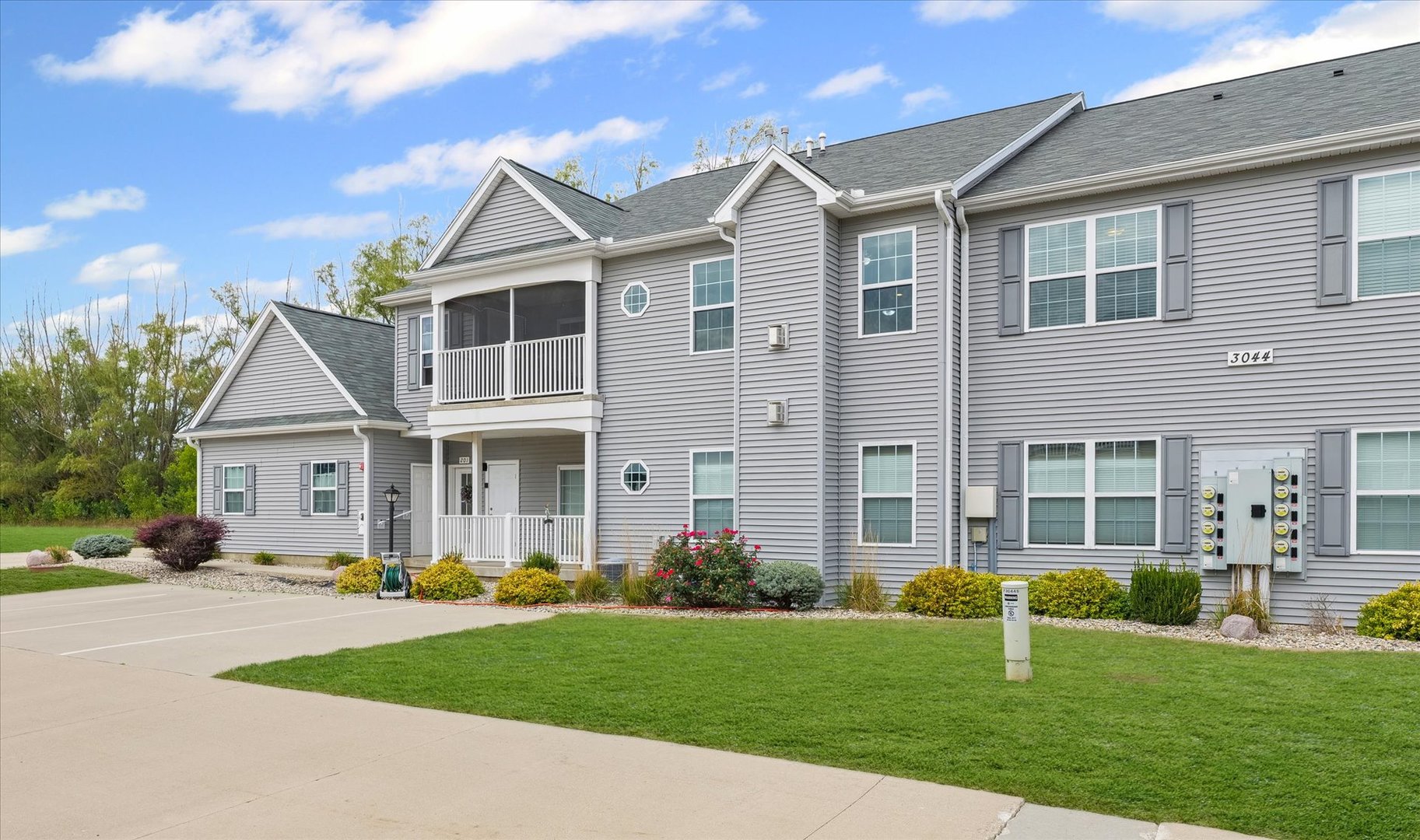 3044 East Stillwater Landing, Unit 201 Urbana, IL 61802 - Photo 3 of 28 a front view of a house with garden and porch