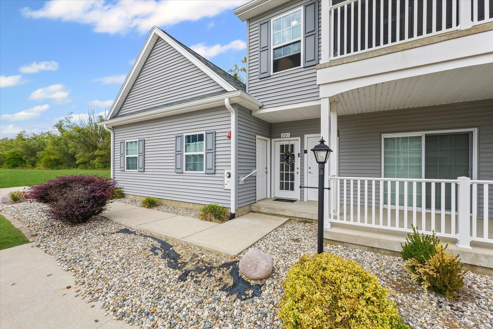 3044 East Stillwater Landing, Unit 201 Urbana, IL 61802 - Photo 4 of 28 a view of a house with a small yard and wooden fence