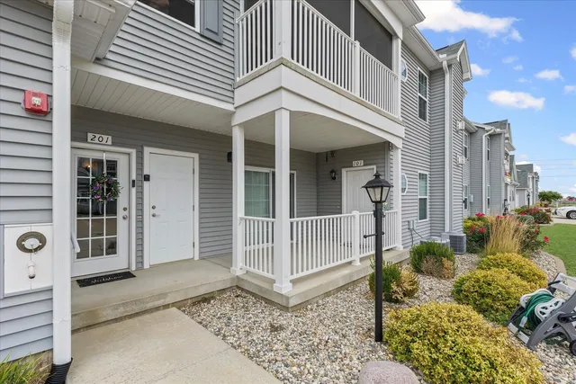 a view of a white building with large windows