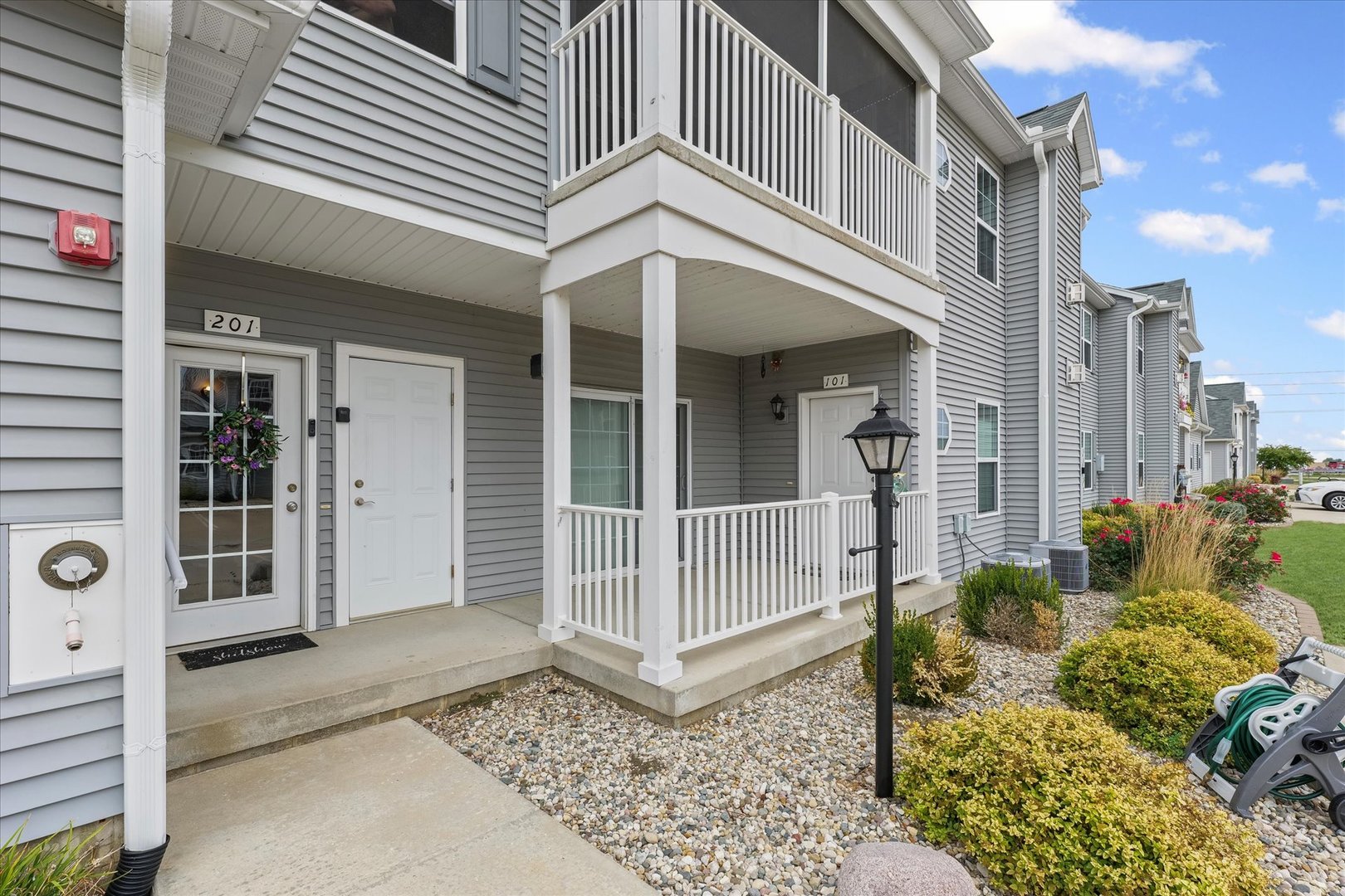 3044 East Stillwater Landing, Unit 201 Urbana, IL 61802 - Photo 5 of 28 a view of a white building with large windows