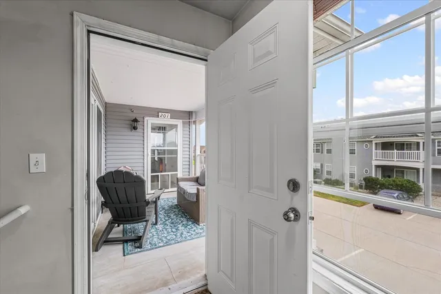a living room with furniture and a floor to ceiling window