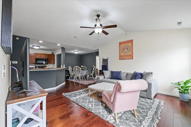 a living room with furniture and a view of kitchen