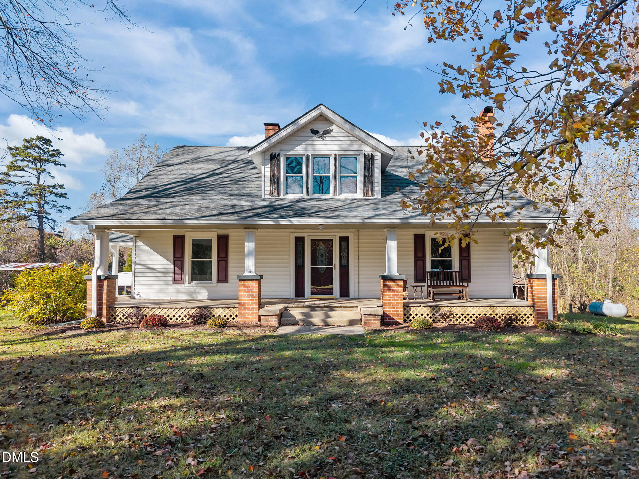 a front view of house with yard and outdoor seating